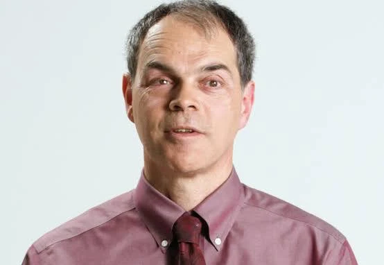 Headshot of Tony Labillois. Tony is wearing a red shirt with a red tie.